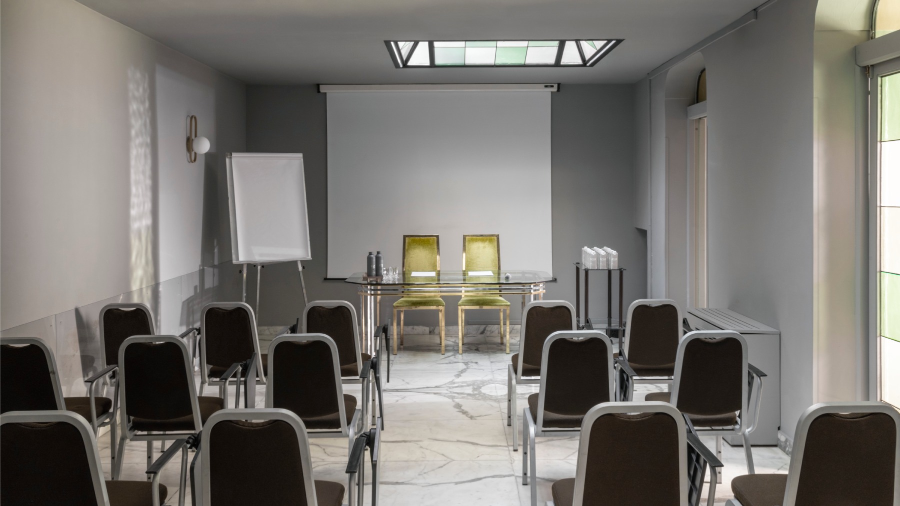 Modern conference room with marble floor, projector, and green velvet chairs - Hotel Milani, BZAR hotels in Rome